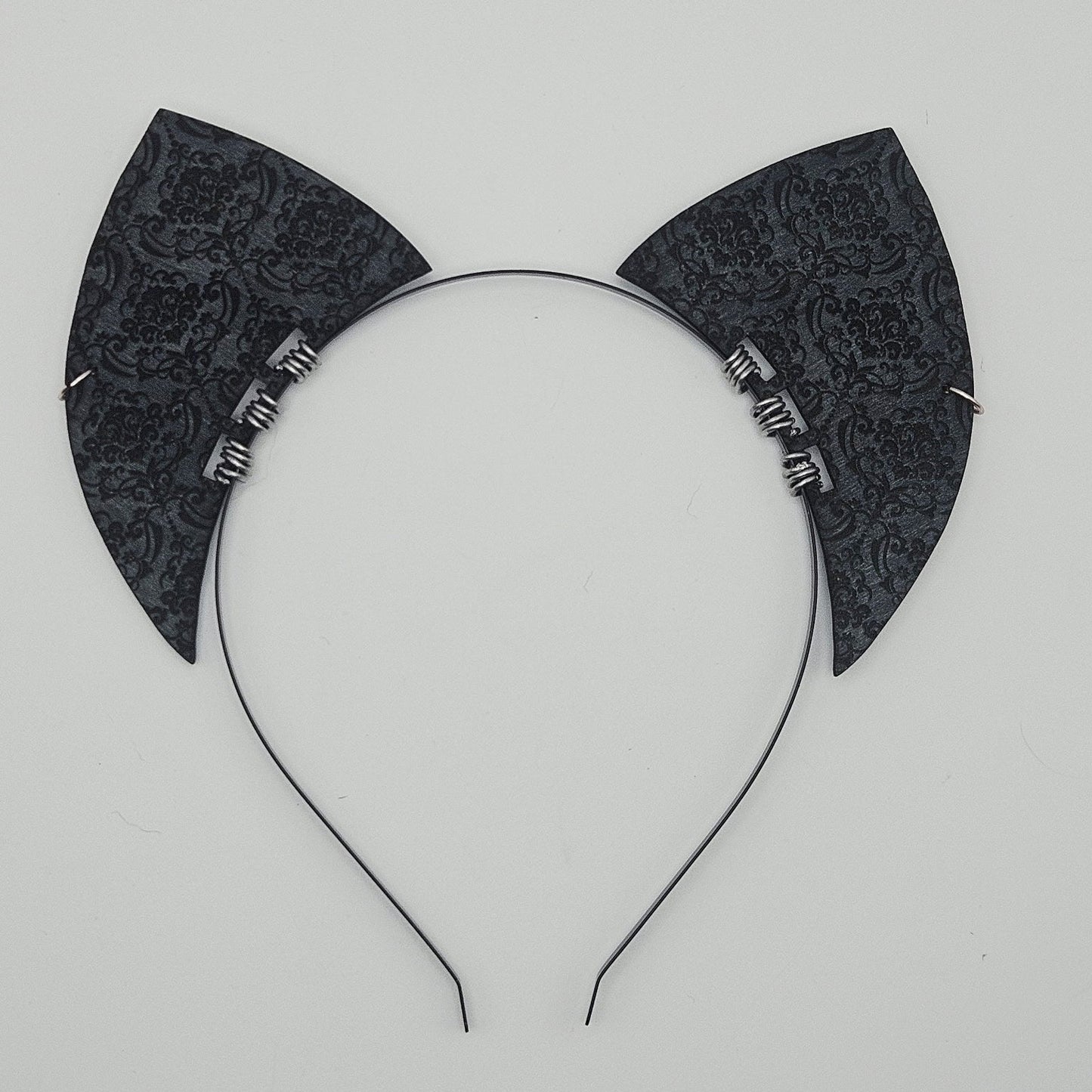 Black cat ear headband on a light gray background
